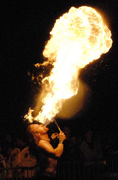 Joshua Lau, who belongs to the Fire Pixies, a dancing group, blows flames during a performance at San Jose State University's homecoming celebration.