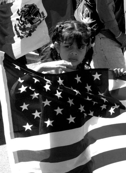 A girl marches with a U.S. flag at hand during a May 1st march. 
