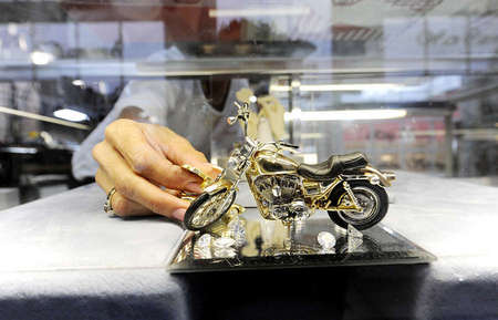 Angela displays a wax-based motorcycle model ordered by a loyal customer. Tim not only makes rings and toy figurines of vehicles but has been asked many times to even create sculpture from sketches.