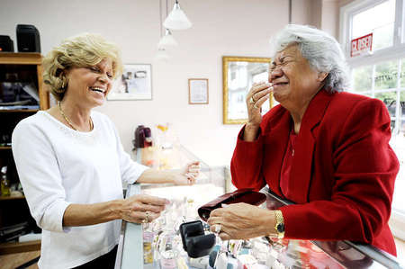 Angela and Sarah Vineyard, a loyal customer of Stoll's, share a laugh after discovering that Ms. Vineyard's daughter-in-law, Lisa, bought the same bracelet as her without her knowing about it. 