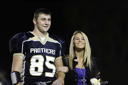 Hillari Caso, right, 17, is escorted by Mitchell Henry during the halftime of the homecoming football game. Hilari said Mitchell, who she considers a friend, is a sweet guy and loves his personality.