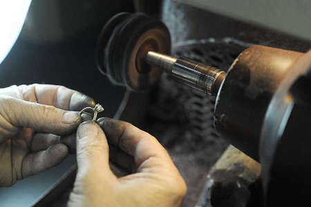 Tim makes some finishing touches to a ring that was pre-ordered by phone. He believes that if the customer knows what they want, the product usually comes out better than expected.