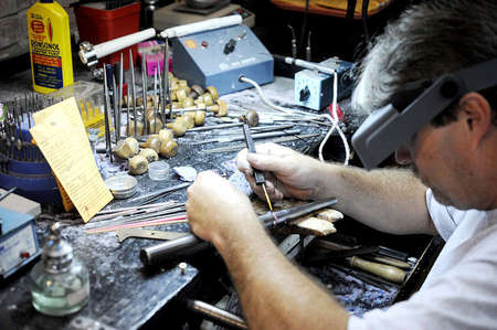 Tim works on a wax ring while doing some detail work to enhance the colors of each individual ring he makes for his customers.