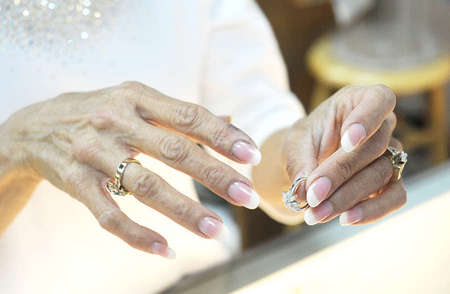 Angela Chamis, 49, Tim Stoll's fiancee, shows a display ring to a customer. She wears the rings that Tim made for her as gifts during their courtship and pending nuptials.