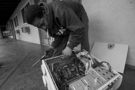 Denise Abdullah rips out computer wires to scrape of copper from all the cables, including microchips that can be recycled to make a profit. She along with her husband, Mahir, have formed what she calls "a business" around recycling computer technologies and other items that carry metal, copper, iron and aluminum. 