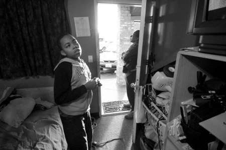 Shadeed watches television as Denise looks to see if the next public bus is arriving near the motel's entrance. Denise who usually takes her son to school tries to get his son to wake up early so they may both catch the bus together. From time to time, it proves difficult for Denise to keep up with his schedule. 