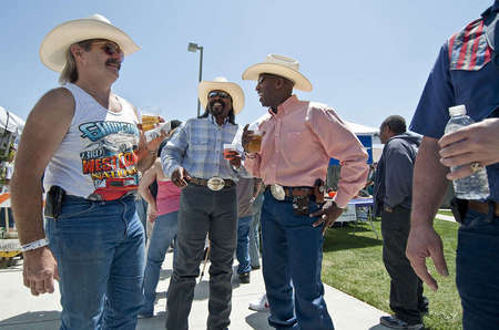 Cowboy enthusiasts and local Morgan Hill-Gilroy residents Art Hannibal (left), Jethro Bledsoe and Darryl Dewaywe Searigril shares some drinks at laughs at the first annual Morgan Hill BBQ Cook-off outside the Community Center.    