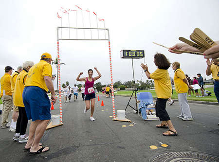 Joann Um,33, from San Diego, arrives at the finish line after the long 10K run from Sunset Park to the Navy North Island Base. This was Joann's first triathlon race. 