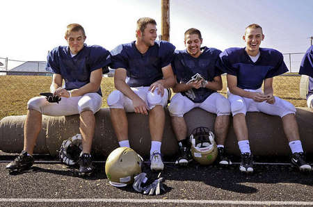 Mitchell Henry, center left, and his teammates take a break from practice. They usually like to joke about game facts and how other teams have performed during the season.