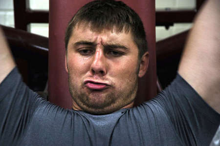 Mitchell Henry lifts weights during a physical training session that Elizabethtown High School football players must complete for core strength. Mitchell likes to push himself to be better and increase his strength so he can succeed on the field.