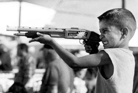 A child holds a toy gun during a Cinco de Mayo festival in San Jose, Calif.