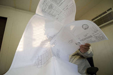 D.S.A. Inspector Don Williams reviews DSA approved documents before his early on-site construction inspection.