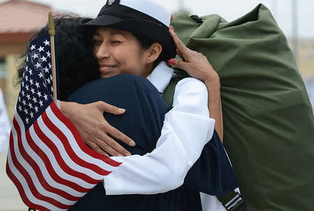Petty Officer Amy Beech of the USS Carl Vinson, embraces her mother, Julia Acosta, after six months of being away at sea. 