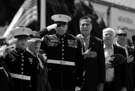 Republican presidential candidate Mitt Romney and Senator John McCain sing along during the national anthem at a memorial day event in San Diego.