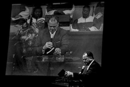 Bishop George W. Brooks of Mount Zion Baptist Church, prays for the health of a church member during Sunday services in Greensboro, N.C. 