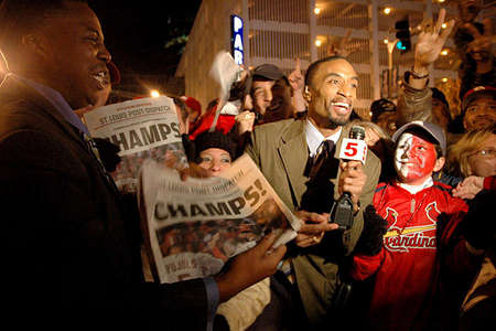 A TV reporter on the verge of giving the news of the St. Louis Cardinals winning the World Series.