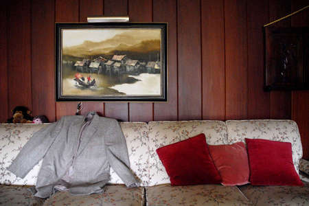 Dwight Bentel's personal items in his living room. the 100 year old man always has his coat ready to go for business.